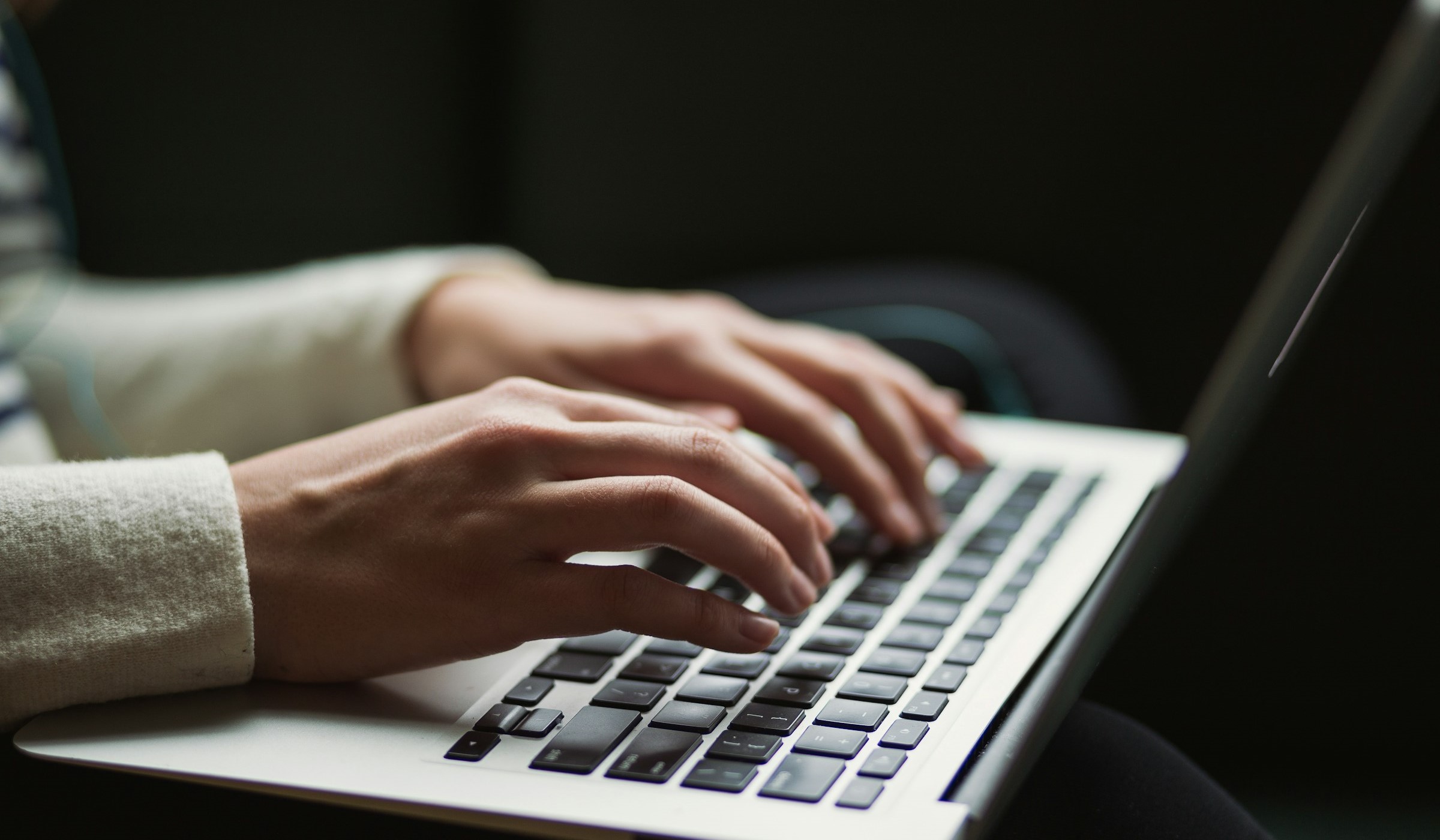 Person typing a stop motion animation plan on a laptop.